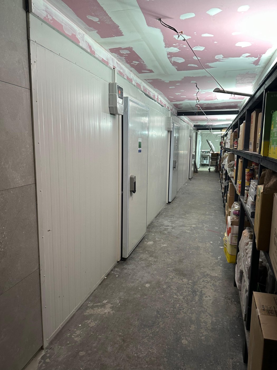 Walk-in cold room doors in a supermarket back-of-house area – cold room installation by DLG Shopfitting