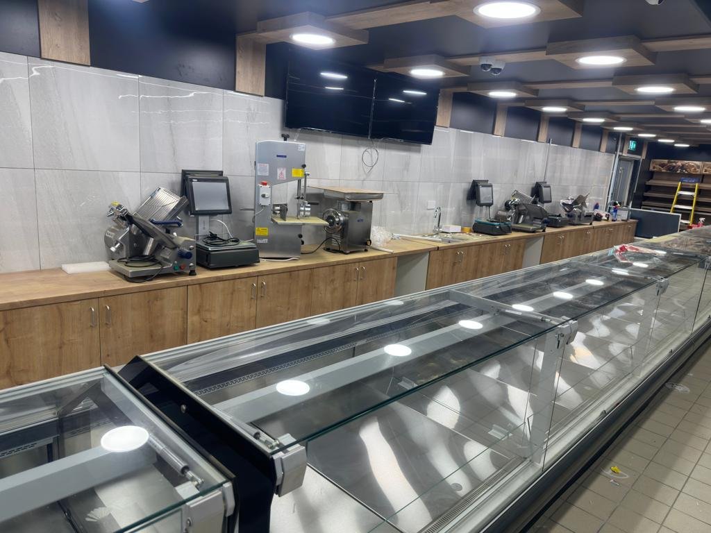 Butchery serve-over display counters with wooden back counters, meat slicers and scales – installed by DLG Shopfitting