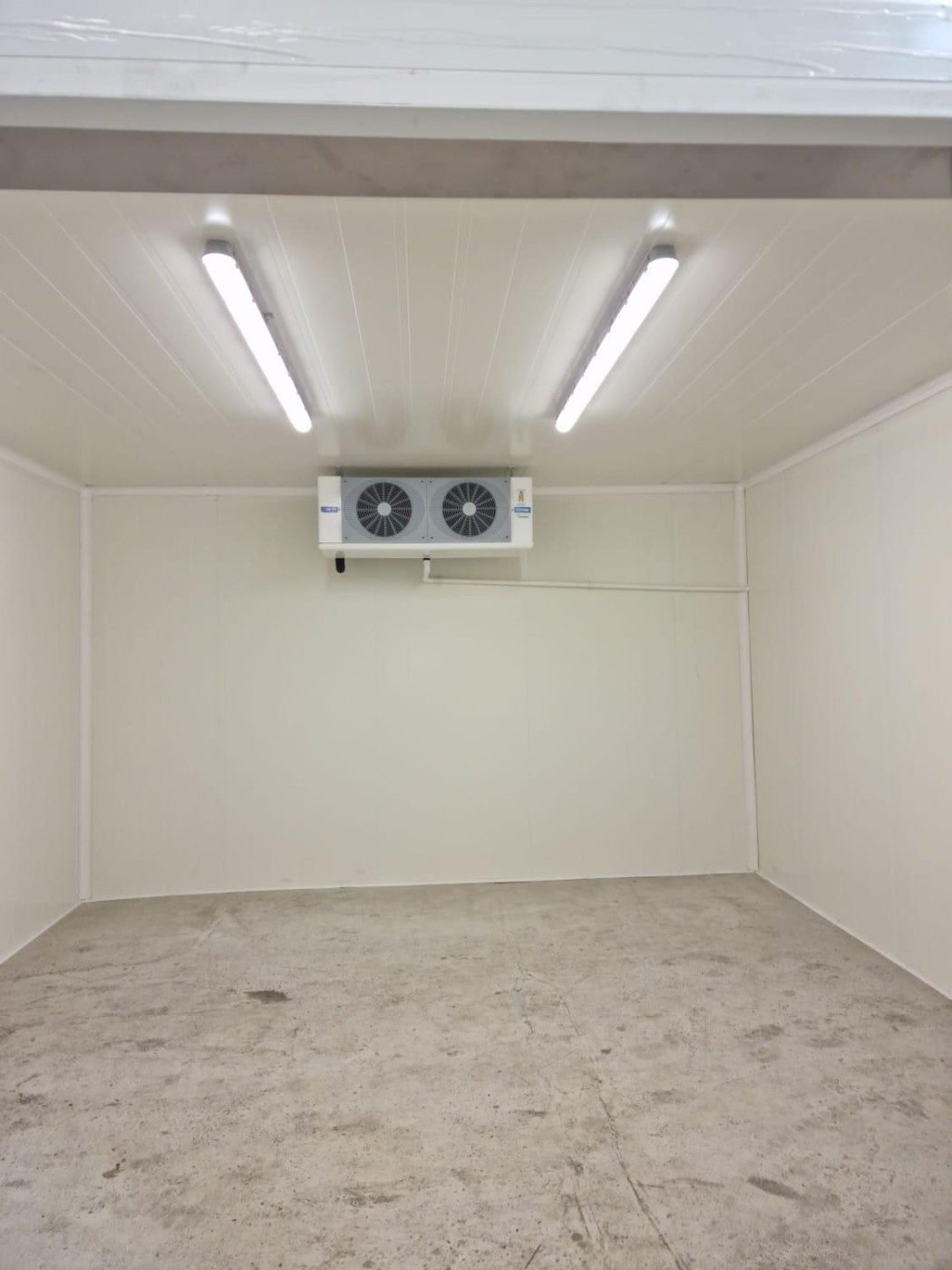 Inside a walk-in cold room with evaporator cooling unit and LED lighting – DLG Shopfitting