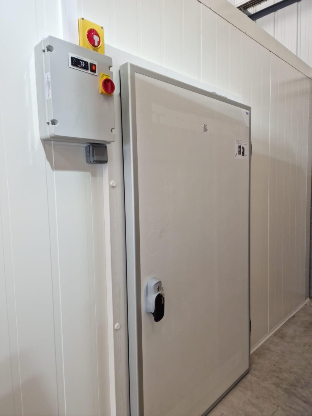 Insulated cold room door with refrigeration control panel – installed by DLG Shopfitting