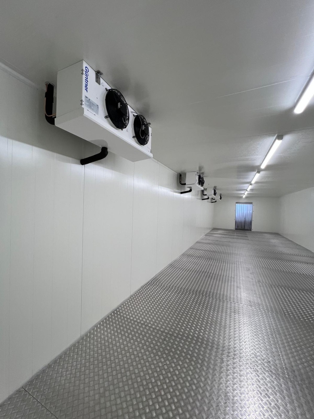 Large walk-in freezer room with chequer-plate floor and evaporators – installed by DLG Shopfitting