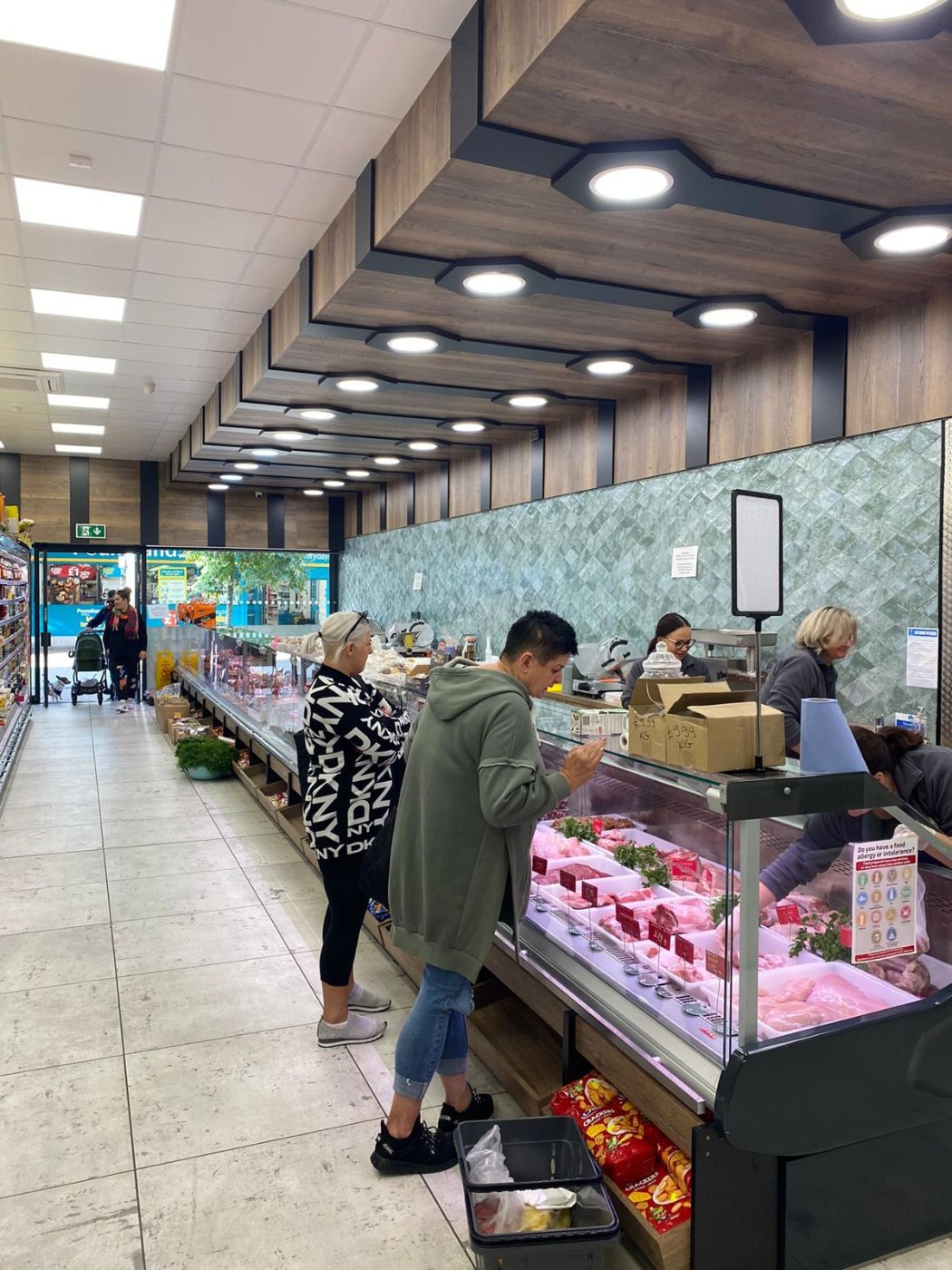 Butchery serve-over counter with customers – butcher shop fitting by DLG