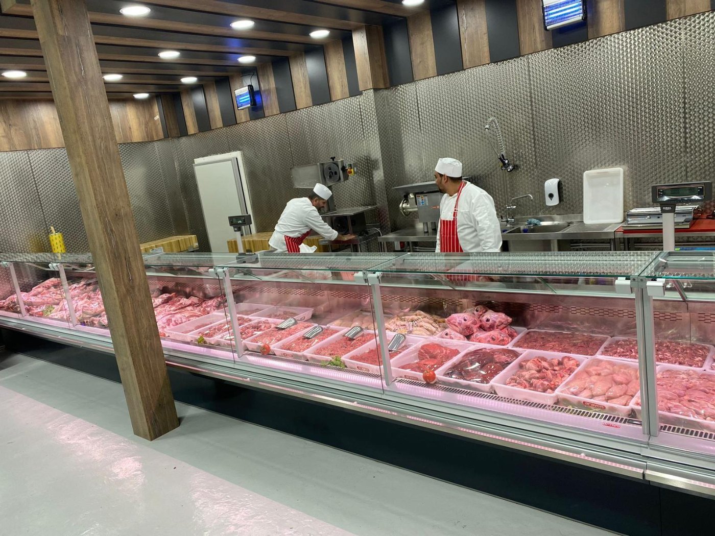 Butchery counter with staff serving – installed by DLG Shopfitting