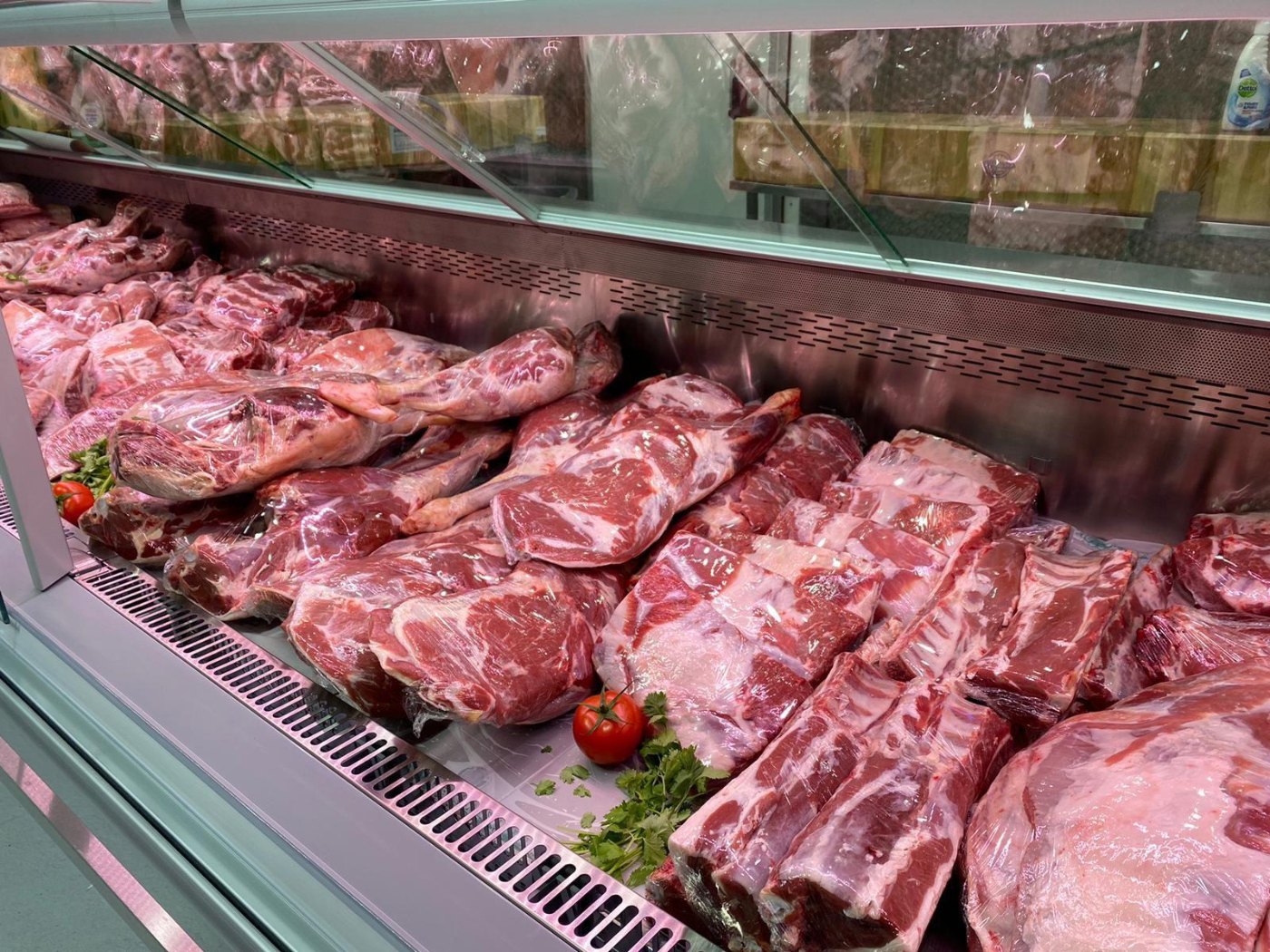 Fresh meat displayed in a refrigerated butchery counter